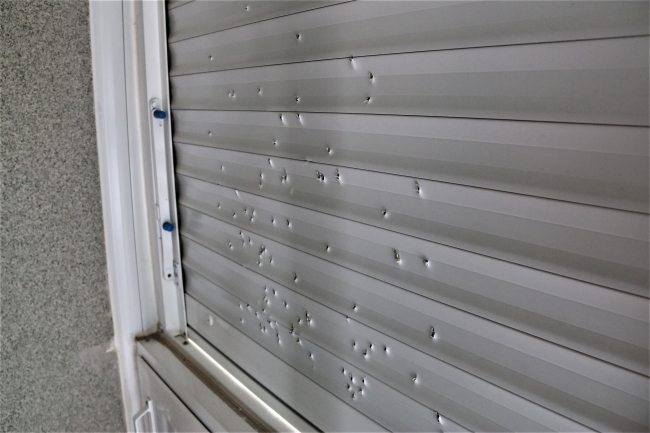 Maganda silahından çıkan saçmalar balkon panjurunu deldi