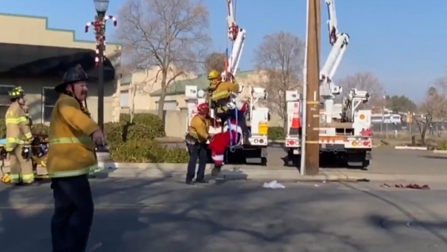 Paraşütlü Noel Baba elektrik tellerine takıldı